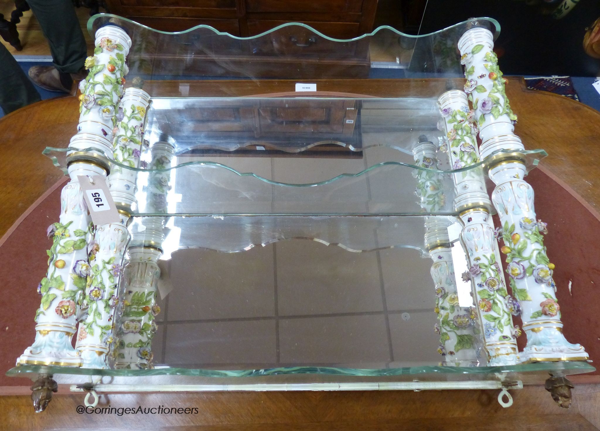 A German porcelain and glass three tier wall bracket, width 65cm, depth 18cm, height 58cm